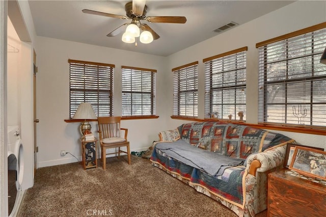 sitting room with carpet flooring, ceiling fan, a healthy amount of sunlight, and washer / dryer