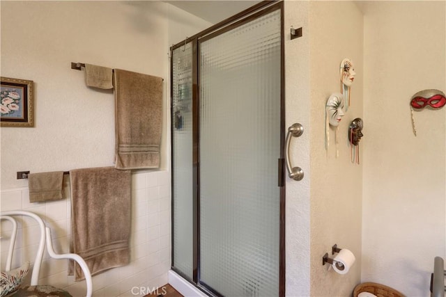 bathroom with tile walls and walk in shower