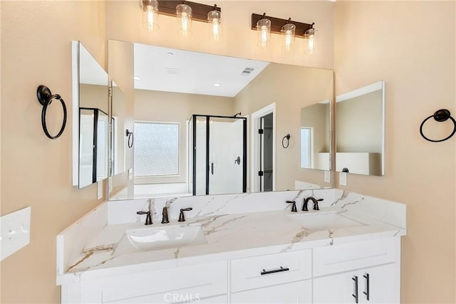 bathroom featuring vanity and an enclosed shower