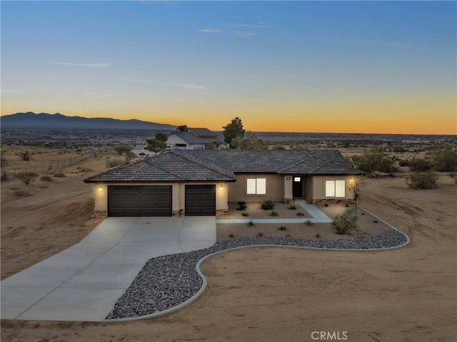 view of front of property featuring a mountain view and a garage