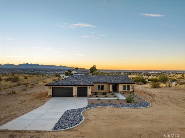 view of front of property with a mountain view and a garage