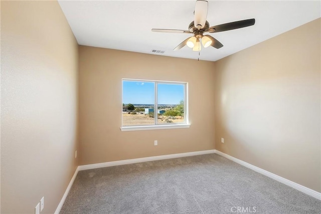 carpeted spare room with ceiling fan