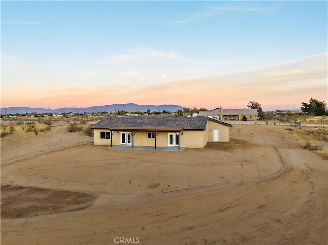 ranch-style home with a mountain view and french doors