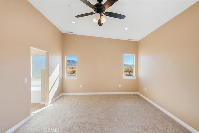 unfurnished room featuring ceiling fan, lofted ceiling, and light carpet