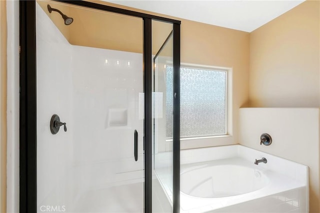 bathroom with separate shower and tub