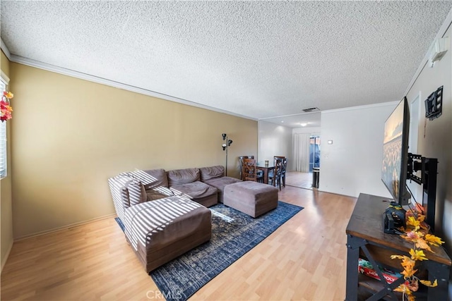 living room featuring hardwood / wood-style flooring, crown molding, and a textured ceiling