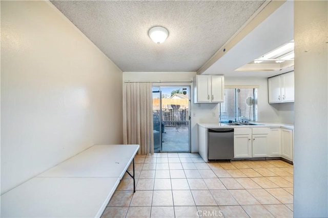 kitchen with a healthy amount of sunlight, white cabinets, and stainless steel dishwasher