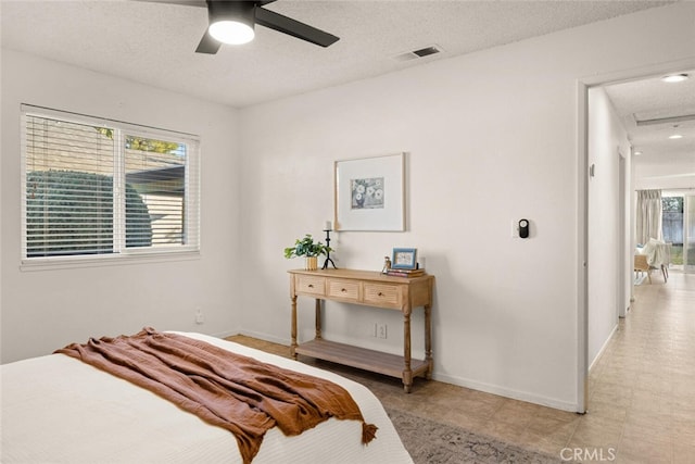 bedroom with a textured ceiling and ceiling fan