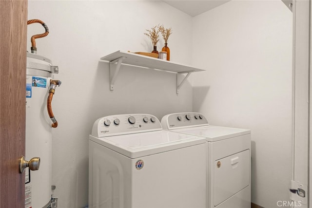 laundry area with water heater and washer and dryer