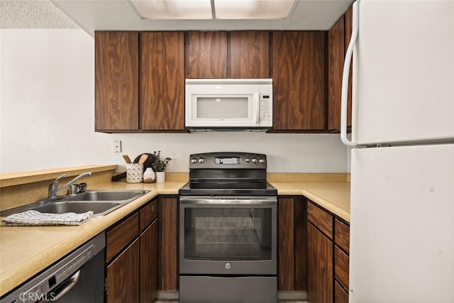 kitchen with sink and white appliances