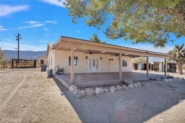 view of front of property featuring central air condition unit, ceiling fan, and a mountain view