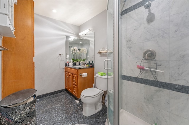 bathroom featuring vanity, toilet, and a shower with door