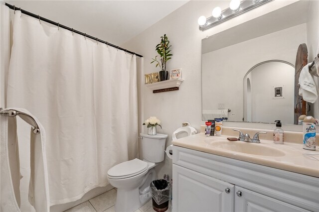 bathroom featuring tile patterned floors, vanity, and toilet