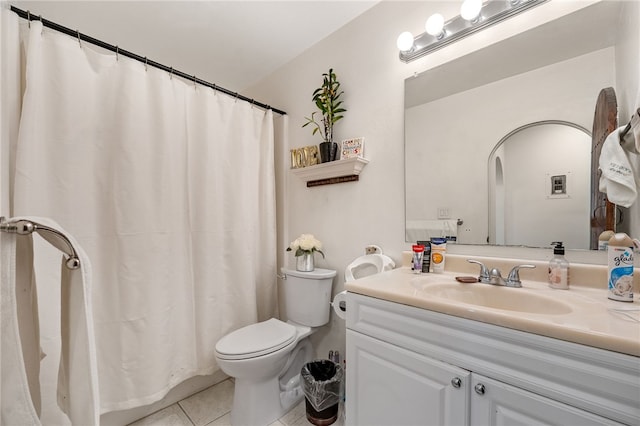 bathroom featuring vanity, toilet, and tile patterned flooring