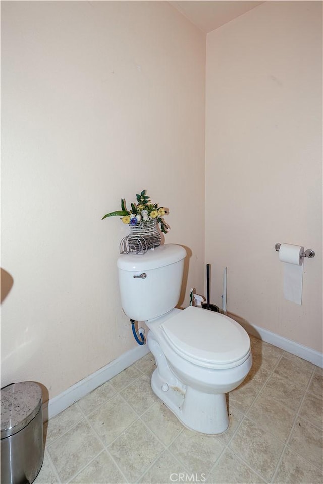 bathroom with tile patterned flooring and toilet