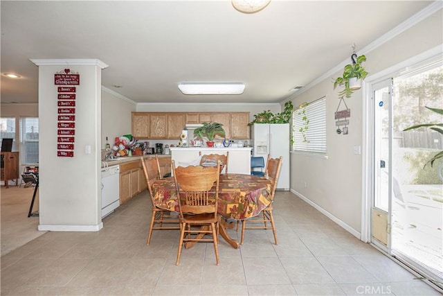 dining area featuring crown molding and light tile patterned flooring