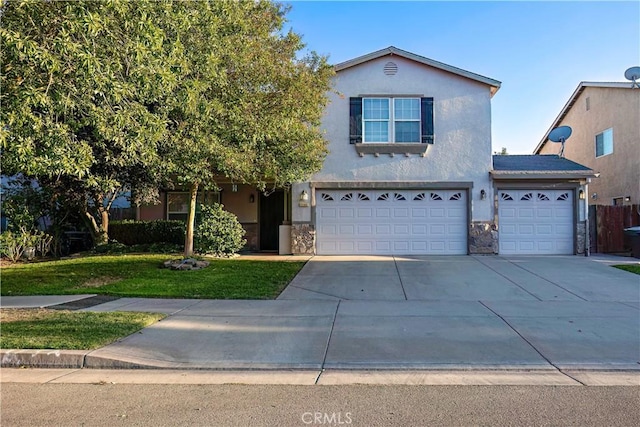 view of property with a garage and a front lawn