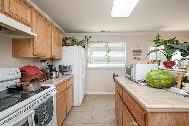 kitchen with tile counters, white appliances, ornamental molding, and light tile patterned floors