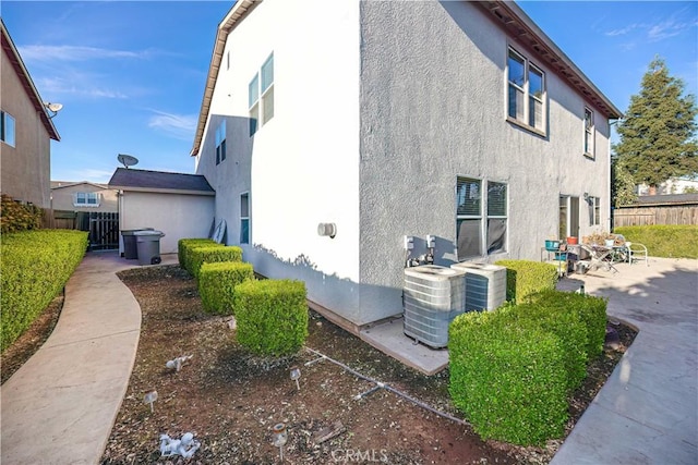 view of side of home featuring central AC unit and a patio area