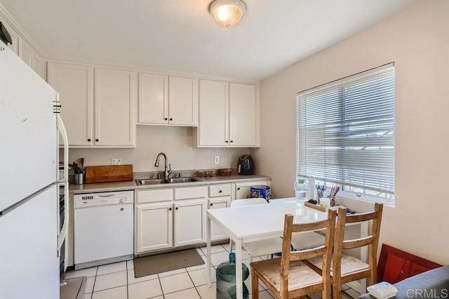 kitchen featuring white cabinetry, sink, light tile patterned floors, and white appliances