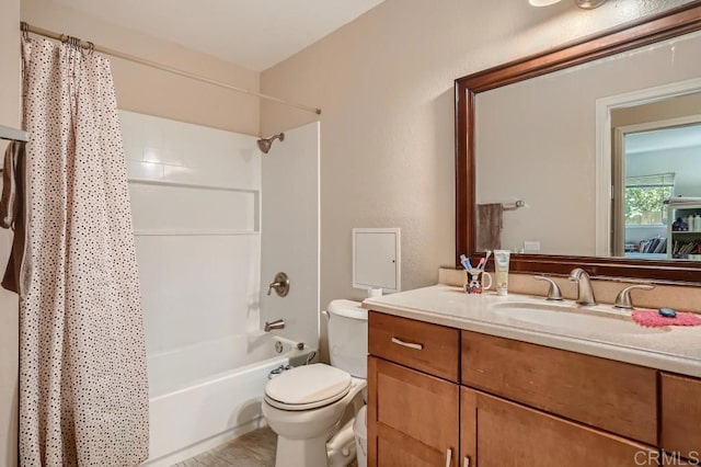 full bathroom featuring vanity, shower / tub combo, and toilet