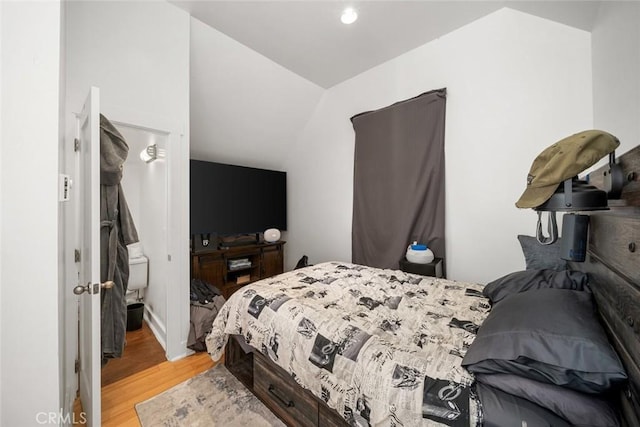 bedroom with light hardwood / wood-style floors and vaulted ceiling