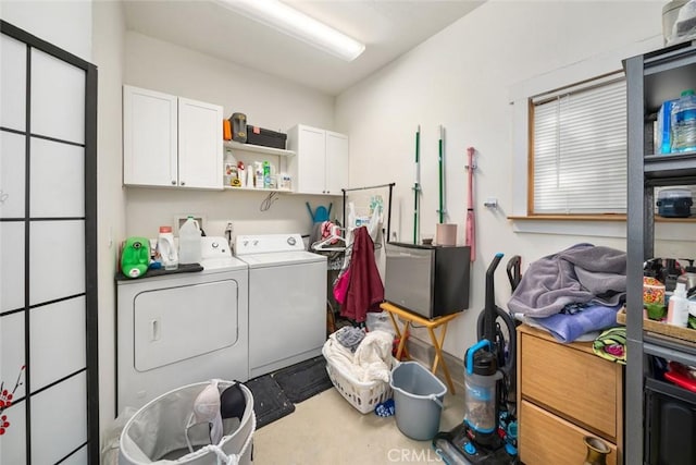 laundry area with washer and clothes dryer and cabinets