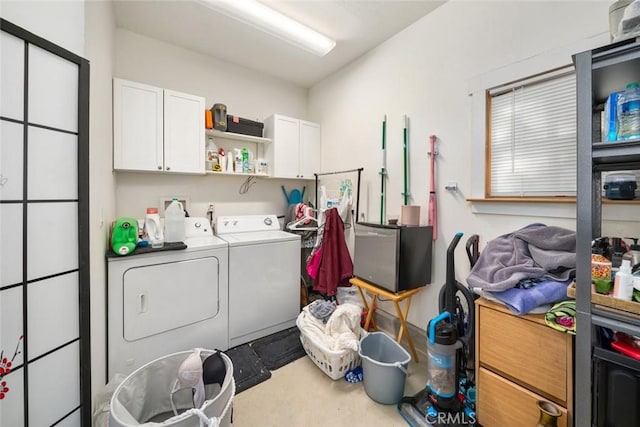 washroom with independent washer and dryer and cabinet space