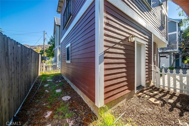 view of home's exterior featuring an outdoor structure and fence