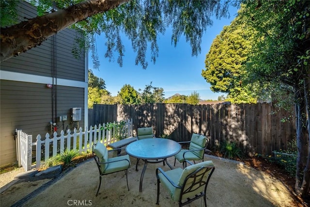 view of patio with outdoor dining area and fence private yard