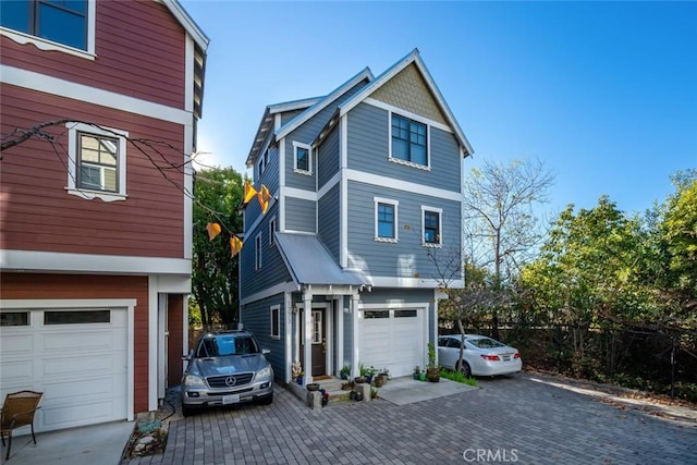 view of front facade with a garage and decorative driveway