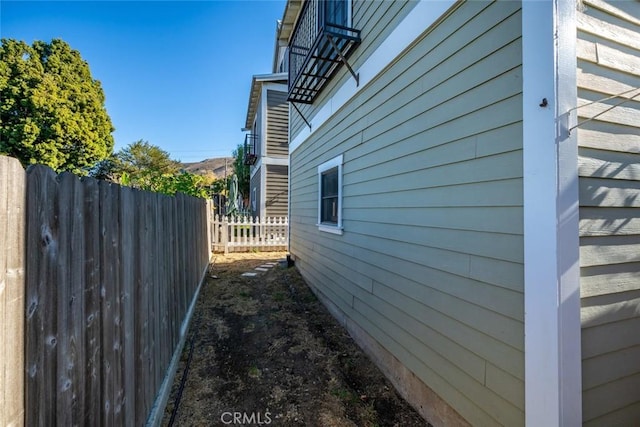 view of side of property featuring fence