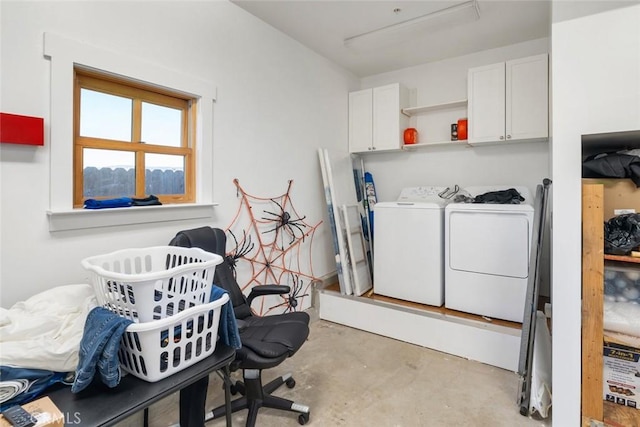 clothes washing area featuring cabinets and independent washer and dryer