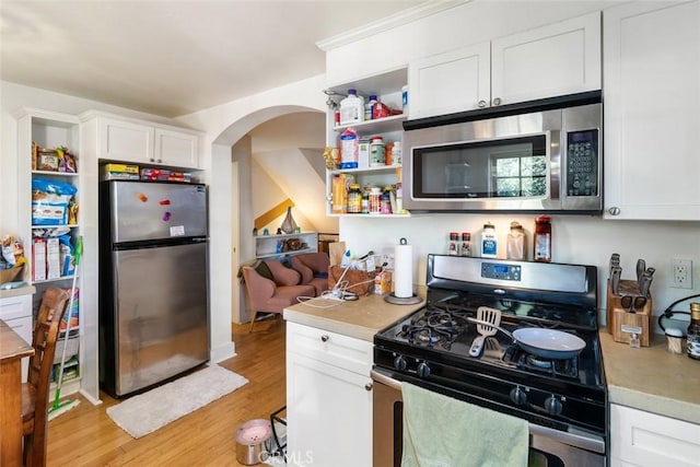 kitchen featuring light hardwood / wood-style flooring, white cabinets, and appliances with stainless steel finishes