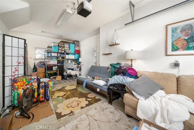 living area featuring a garage and concrete floors