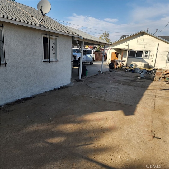 view of side of property with a carport