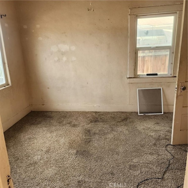 carpeted spare room with a healthy amount of sunlight