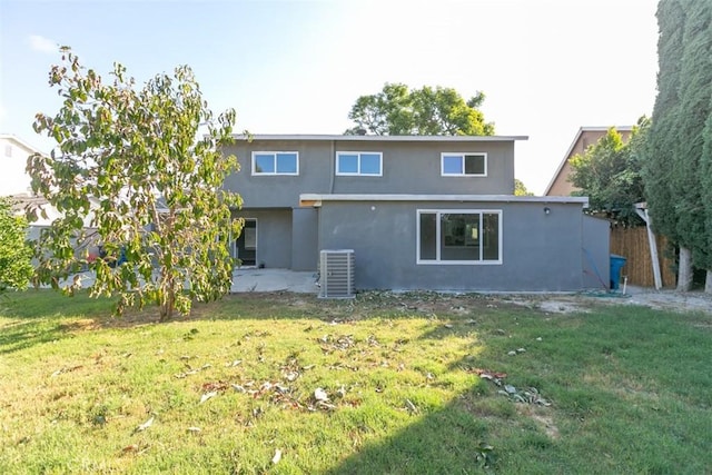 back of property featuring central air condition unit, a patio area, and a yard