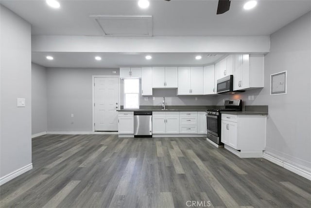 kitchen with white cabinets, sink, dark hardwood / wood-style flooring, and stainless steel appliances