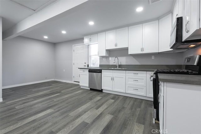 kitchen featuring white cabinets, dark hardwood / wood-style flooring, and stainless steel appliances