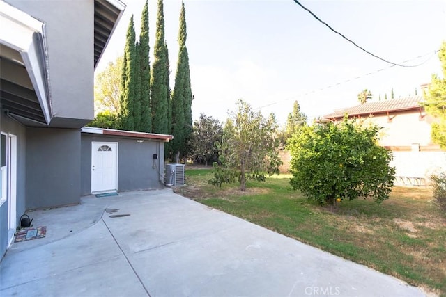 view of yard with a patio and central AC unit