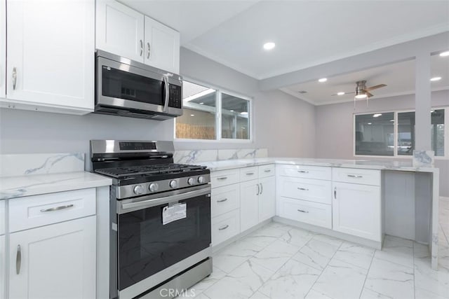 kitchen featuring appliances with stainless steel finishes, light stone counters, ornamental molding, ceiling fan, and white cabinets