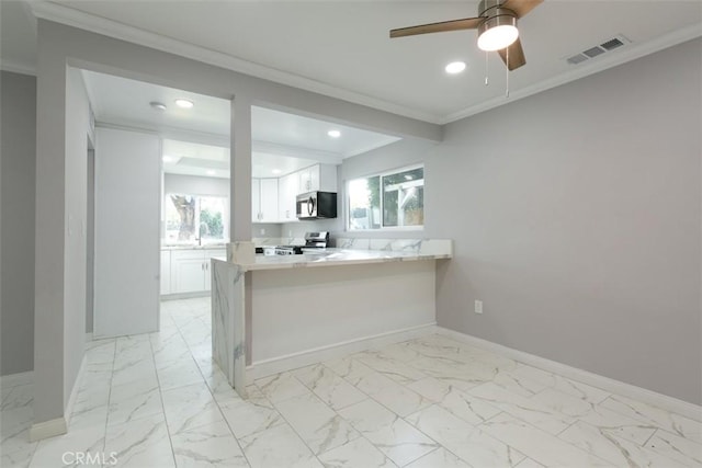 kitchen with white cabinets, ceiling fan, ornamental molding, appliances with stainless steel finishes, and kitchen peninsula