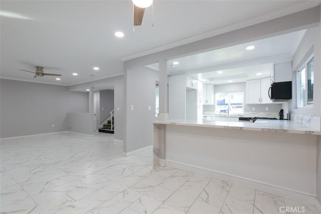 kitchen with white cabinets, ceiling fan, kitchen peninsula, and crown molding