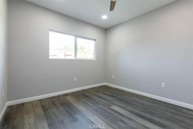 empty room featuring ceiling fan and dark wood-type flooring