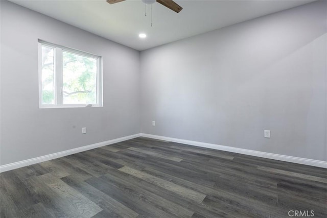 empty room featuring ceiling fan and dark wood-type flooring