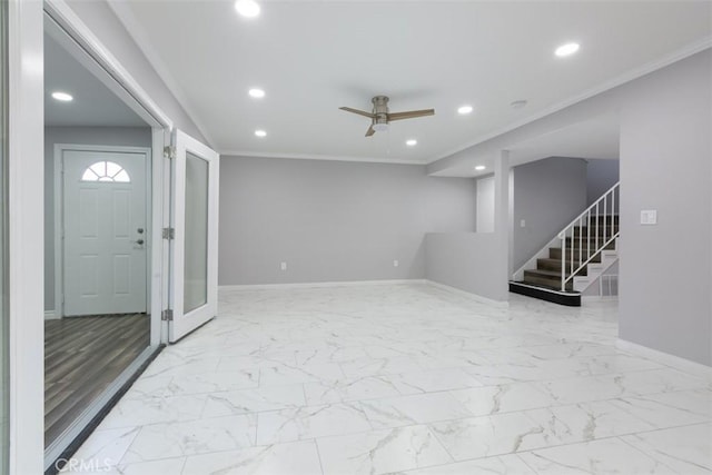 foyer with ceiling fan and ornamental molding