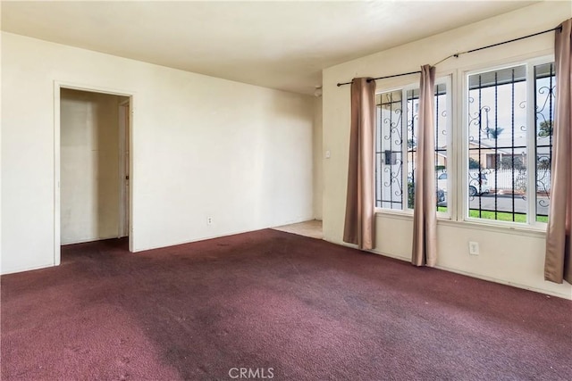 carpeted empty room featuring a wealth of natural light