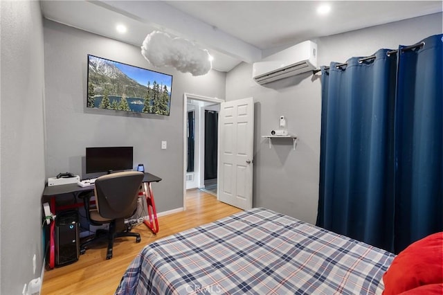 bedroom featuring a wall unit AC, wood-type flooring, and beam ceiling