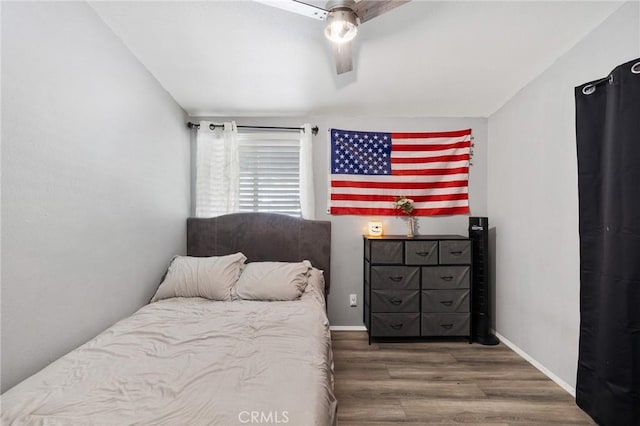 bedroom featuring ceiling fan and dark hardwood / wood-style flooring